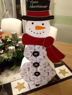 a snowman made out of wine corks sitting on top of a table