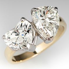 two pear shaped diamond engagement rings in yellow gold