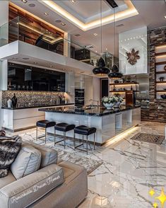 a living room filled with furniture next to a kitchen