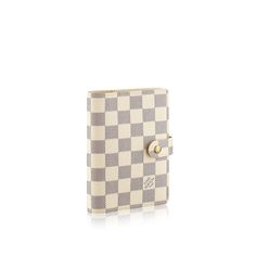 a white and grey checkered notebook with a button on the front, sitting against a white background