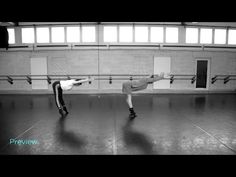 two people doing tricks in an empty room