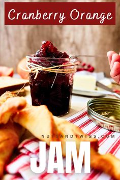 side view of the cranberry orange jam in a mason jar with a spoon pulling some up.