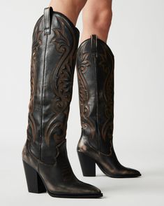 A  Western   boot  is a requirement for any wardrobe and we’re obsessed with LASSO. This knee-high pair features whipstitching detail and a towering block heel.  3.75 inch heel height  Size 6 measurements: 15 inch shaft circumference, 13.25 inch shaft height Size 8 measurements: 15.75 inch shaft circumference, 14.25 inch shaft height Size 10 measurements: 16.75 inch shaft circumference, 15 inch shaft height Leather upper material  Textile and synthetic lining Synthetic sock Synthetic sole  This product is made with premium leather and is individually hand finished. As a result, the product can vary slightly from the pictures. Imported Brown Cowboy Boots, Steve Madden Store, Black Cowboy, Steve Madden Boots, Western Boots Women, Western Boot, Cowgirl Boots, Steve Madden Shoes, Brown Boots