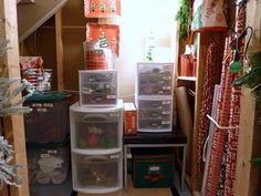 several storage containers are stacked on top of each other in this small room filled with christmas decorations