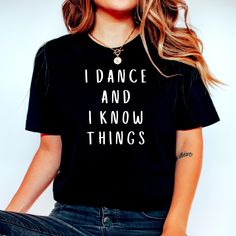 "Celebrate one of the world's most awesome people with our I Dance And I Know Things Funny Dance T-Shirt. It's made of the finest stuff with super soft ringspun cotton while providing the perfect amount stretch that everyone is looking for. I Dance And I Know Things Funny Dance Shirt Dance Class Shirt Dance Instructor Dancer Gift Dancing Shirt Cute Dance Shirt Dance Shirt Dancer OUR SHIRTS ARE PRETTY GREAT, no really :) ✔ ALL SHIRTS are super soft and comfy. We're really picky about selecting only best materials around. All garments are printed with love and care here in the USA at one of our two materials partners; whichever is closest to your location. Our printing methods are second to none with cutting-edge direct to garment printing processes. ✔ Printing Processes: We use a special di Cotton Tops With Letter Print For Dance, Cotton Letter Print Tops For Dance, Cotton Short Sleeve Tops For Dance Class, Hip Hop Dance Cotton T-shirt, Hip Hop Dance Tops With Short Sleeves, Cotton Hip Hop T-shirt For Dance Class, Cotton Hip Hop T-shirt For Dance, Casual Dance Shirt With Graphic Print, Cotton Tops With Letter Print For Dance Class