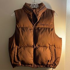 Brand New. Chocolate Brown Quilted Puffer Vest Mock Neck And Full Zip Closure Signature Pantone Branded Logo On Chest Lower Pockets Hidden Hood In Collar Pantone Brown, Brown Puffer Vest, Brown Puffer Jacket, Brown Puffer, Hidden Hood, Quilted Puffer Vest, Clothes Ideas, Puffer Vest, Chocolate Brown