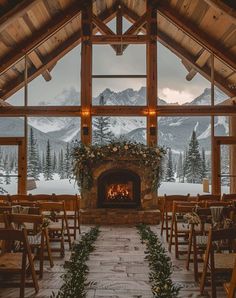 the inside of a building with wooden chairs and fireplace