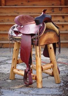 a saddle sits on top of a wooden stool