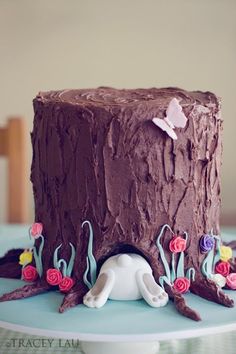 there is a chocolate cake with flowers on the top and decorations in the bottom layer