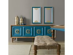 a blue dresser with two mirrors above it and a bench in front of the mirror