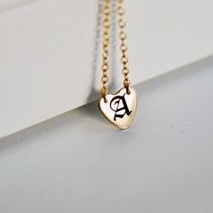 Old English Letter engraved heart necklace. Custom initial heart pendant. Perfect everyday necklace and great for layering with longer chains or a sweet gift for moms, sisters or friends. It's a great birthday gift. *** 14k gold filled heart charm*** Initials engrave by laser engraving by me.***Chain is 14" 16" or 18" available from drop down menu.*** Heart measurement : 10mm diameter. HOW TO ORDER !1) FROM FIRST DROP DOWN MENU !Choose your necklace length 14" 16" or 18" 2) IN THE CUSTOMIZE IT B 14k Gold Filled Heart Pendant Charm Necklace Gift, Minimalist Personalized Heart Pendant Charm Necklaces, Personalized Heart Pendant Initial Necklace For Everyday, Minimalist Personalized Heart Pendant Charm Necklace, 14k Gold Filled Charm Necklace For Valentine's Day Gift, Minimalist Heart Necklace With Initials For Personalized Gift, Dainty Heart Charm Necklace For Best Friend Gift, Dainty Heart Charm Necklace For Best Friend, Mother's Day Best Friend Gift Initial Pendant Charm Necklace