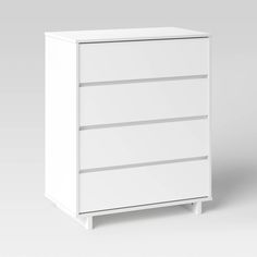 a white dresser with three drawers on it