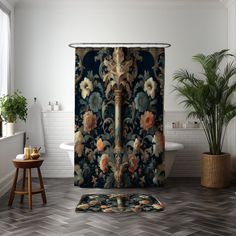 a bathroom with a shower curtain that has an ornate design on it and a potted plant in the corner