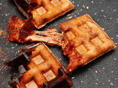 four waffles with bacon on them sitting on the ground next to each other