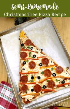 a homemade christmas tree pizza in a pan with olives and pepperoni on it