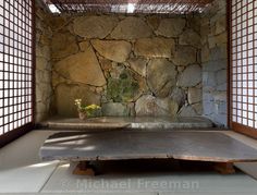 an empty room with stone walls and flooring