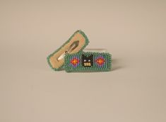 Native American made Original design 1 Pair of barrettes. Tiny hero on green background. Beaded with leather backing Snap style clips Measures approx. 2" (5 cm) x .75" (2 cm) Seed Bead Barrettes, Beaded Barrettes, Embroidery Jewelry, Green Background, Green Backgrounds, Barrettes, American Made, Seed Bead, Original Design