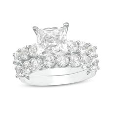 an engagement ring set with a princess cut diamond surrounded by round brilliant czrs