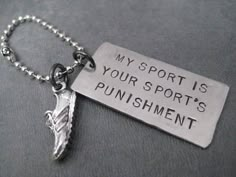 a key chain with a metal tag that says, my sport is your sports's punishment