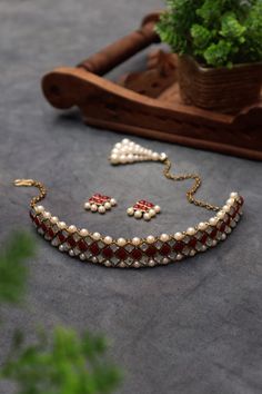 Kundan and Pearl Choker Necklace Set For Women & Girls Material : Kundan, faux pearl, metal, and glass Dimension : Necklace - 16 x 1 inches approx. Earrings - 0.8 x 0.5 inches approx. All you need to complete your look is our Kundan Choker Necklace Set! This exclusive necklace set has kundan stones joined together in a geometric design. The entire look is completed with little pearls set around the edges. Closure type: Necklace - S-hook, Earrings - Push Back Finish: Antique gold Additional infor Pearl Jewelry Sets For Party And Festivals, Pearl Jewelry For Party And Festivals, Festive Pearl Necklace For Party, Party Pearl Jewelry For Festivals, Beaded Metal Jewelry Sets For Party, Festival Pearl Necklace For Parties, Party Festivals Pearl Jewelry, Festive Party Pearl Necklace, Beaded Kundan Choker Necklace For Party