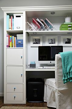 a white desk with a computer on top of it and lots of bookshelves