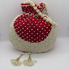 "beautiful artisan handmade decorative pearl beaded velvet fabric wedding favor bag with pearl handle | pearl potli handbag for wedding gift Package Contents: 1 Size: 10\" x 8\" Designed with the heart, this beautiful Potli or batawa bag are eye catchy and made of premium material. Key Features: Ark Work. This potli is good match with both Indian and western outfits and are superb for wedding and festive parties. This would be best complement to your designer saree, lenhga or any other kind of d Beaded Potli Bag For Festivals And Gifts, Beaded Potli Bag For Festivals Gift, Festival Beaded Potli Bag As A Gift, Festive Pearl Embroidered Evening Bag As Gift, Festive Pearl Embroidery Evening Bag, Pearl Embroidery Evening Bag For Festivals, Pearl Embroidered Evening Bag For Festivals, Traditional Pearl Embroidered Potli Bag For Reception, Traditional Potli Bag With Pearl Embroidery For Reception