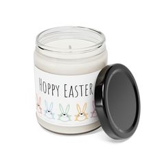 a candle that is sitting next to a container with an easter bunny design on it