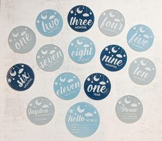 twelve blue and white stickers with the words three nights written in different languages on them