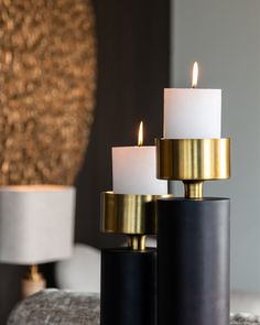 three lit candles sitting on top of a table