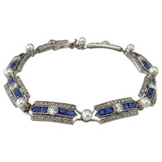 Circa 1910-1915, this magnificent antique French Belle Epoque link bracelet is composed of a repeating geometrical design centered by an Old European cut diamond flanked by four calibrated blue sapphires and two rows of small glittering rose cut diamonds. The links are connected by a single white pearl (8 in total) measuring 4mm. The bracelet measures 7.3 inches long and is fashioned in platinum with delicate milgrain hand-engraving. The diamonds total approximately 2.00 carats. Sapphire And Pearl, Geometrical Design, European Cut Diamonds, Belle Epoque, Dream Jewelry, Rose Cut Diamond, Hand Engraving, Pearl Bracelet, Rose Cut