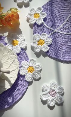 crocheted flowers and plates on a table