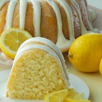 a lemon pound cake with white icing and sliced lemons