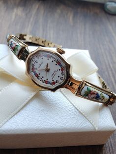 Watches for women with enamel inserts. Very beautiful, feminine, look great on a woman's wrist. They can be a great gift for lovers of classic vintage style. The watch is delivered in a beautiful box, so it is perfect as a gift. This watch is gilded (gilding is confirmed by the hallmark Au) with enamel inserts. Enamel is the manufacture of works of art using glassy powder, enamel on a metal substrate, a kind of applied art. The process consisted of three stages: first, the master prepared a base Retro Round Watch As Gift, Retro Round Watch For Gift, Vintage Jewelry And Watches With Round Dial For Gift, Nostalgic Analog Watch As Gift, Antique Watches With Round Dial For Gift, Analog Jewelry And Watches With Round Dial For Gifts, Jewelry Y2k, Watch Women's, Small Watch