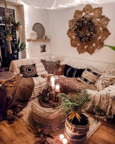 a living room filled with lots of pillows and blankets on top of a wooden floor