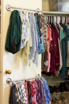 a closet filled with lots of different types of clothing hanging on the wall next to shoes