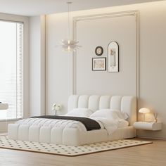 a white bedroom with a large bed in it