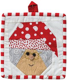 a red and white patchwork quilt with a face on it