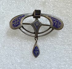 Wonderful antique pin from the arts & crafts era. It is 800 silver with blue niello  enameling and set with a blue sapphire stone. It measures 1.25" x 1 3/8".  Condition is very good. Collectible Hallmarked Blue Brooches, Antique Blue Jewelry With Brooch, Silver Victorian Enamel Brooches, Victorian Silver Enamel Brooches, Collectible Art Nouveau Hallmarked Brooch, Ornate Silver Enamel Brooches, Antique Blue Collectible Brooches, Blue Art Deco Formal Brooch, Antique Blue Enamel Brooches