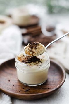 a spoon with some food in it on a plate