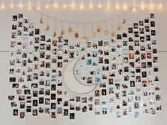 a wall covered in pictures and lights next to a crescent