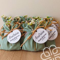 three bags with tags tied to them sitting on a table