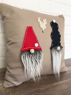 a pillow with two gnomes on it