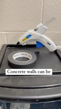 a tape dispenser on top of a trash can with the words concrete walls can be cut off