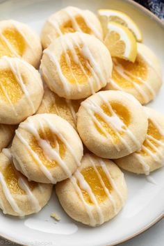 a white plate topped with lemon cookies covered in icing