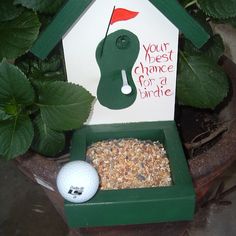 a bird house with a golf ball in it