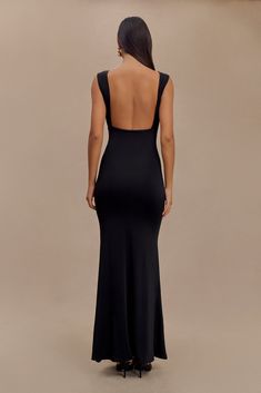 Understated glamour. The MALIA Slinky Ruched Maxi Dress is a masterclass in elegant design. Featuring a sophisticated boat neckline and daring open back, this bodycon dress flatters your silhouette with gathering detail at the bust. The fishtail hem adds a touch of drama, creating a graceful flow with every step. Fully lined for a smooth finish, Malia is the epitome of refined style. Fitted V-back Party Dress, Elegant Stretch Maxi Dress With Ruched Back, Fitted Party Dress With V-back, Party Maxi Dress With Ruched And Low Back, Party Dress With Cutout Back, Backless Ruched Evening Dress, Elegant Stretch Backless Dress In Elastane, Ruched Back Backless Evening Dress, Formal Backless Maxi Dress In Elastane