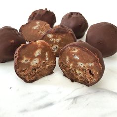 some chocolates are sitting on a marble surface