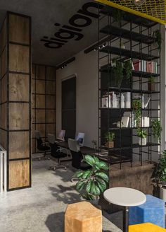 an office with plants and bookshelves on the walls, along with tables and chairs