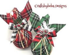 three plaid christmas ornaments with bows on them