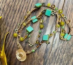 "This is a freshly made ONE-OF-A-KIND necklace or bracelet. It measures approximately 22\" in length.  I used a natural mother-of-pearl, button/clasp.  I used a medium-thick nylon chord to crochet, the semi-precious stones in chartreuse, copper, Swarovski crystals, and glass beads. I loved the colors in this necklace/bracelet.  Chartreuse, turquoise, copper, olive jade, and glass beads were used. Matching bracelet can be found here: https://www.etsy.com/your/shops/me/listing-editor/edit/1658767070" Bohemian Single Strand Gold Beaded Bracelet, Bohemian Single Strand Beaded Bracelets As Gift, Bohemian Single Strand Lariat Beads, Handmade Double Strand Beads For Gifts, Handmade Artisan Double Strand Beaded Necklace, Handmade Double Strand Beads As Gift, Bohemian Handmade Double Strand Beads, Handmade Double Strand Beads For Gift, Handmade Unique Double Strand Beaded Necklaces